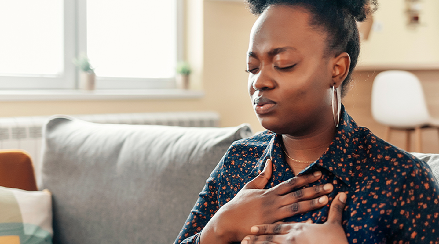 woman placing hands on chest