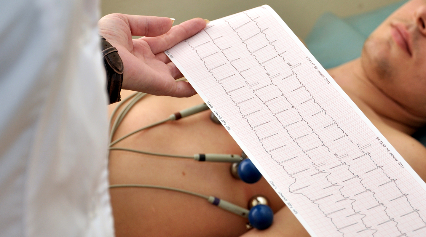 doctor reading patient EKG exam reading