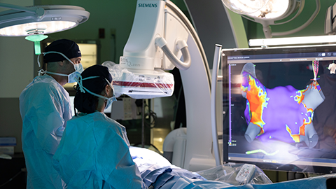 MCVI surgeons in OR looking at monitor