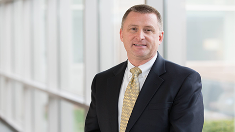 Stephen Demers standing in front of window
