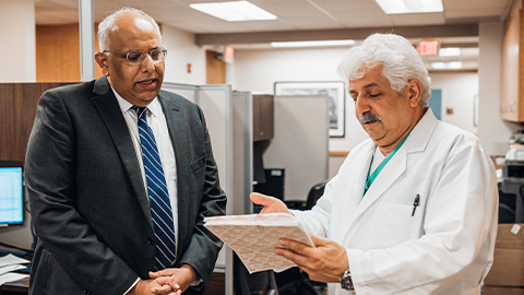 dr. basit javaid and dr. seyed ghasemian looking at patient chart
