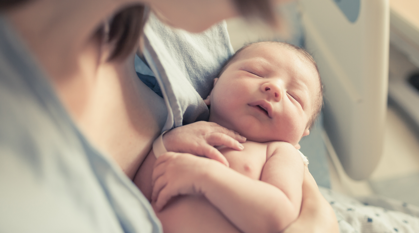 newborn resting in mothers arms