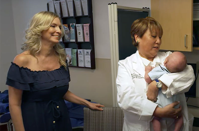 Dawn and Dr. Kang holding her newborn baby