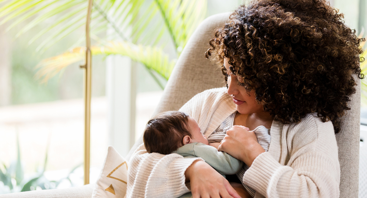 holding baby to breastfeed