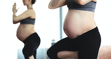 pregnant woman holding yoga pose thumbnail