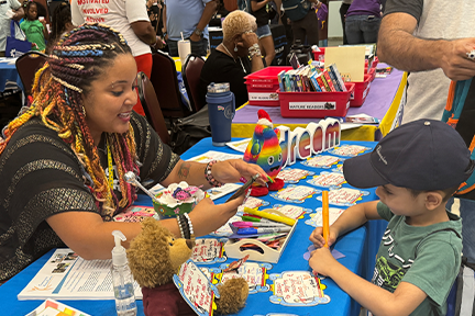 child coloring at art station at OCAT Miramar