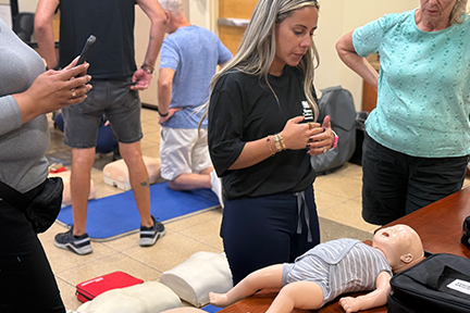 CPR trainer teaching on infant doll