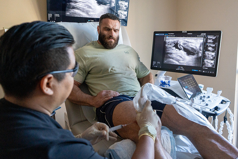 Dr. Giorgio Negron injecting PRP into Kyrylo's knee using ultrasound-guided imaging
